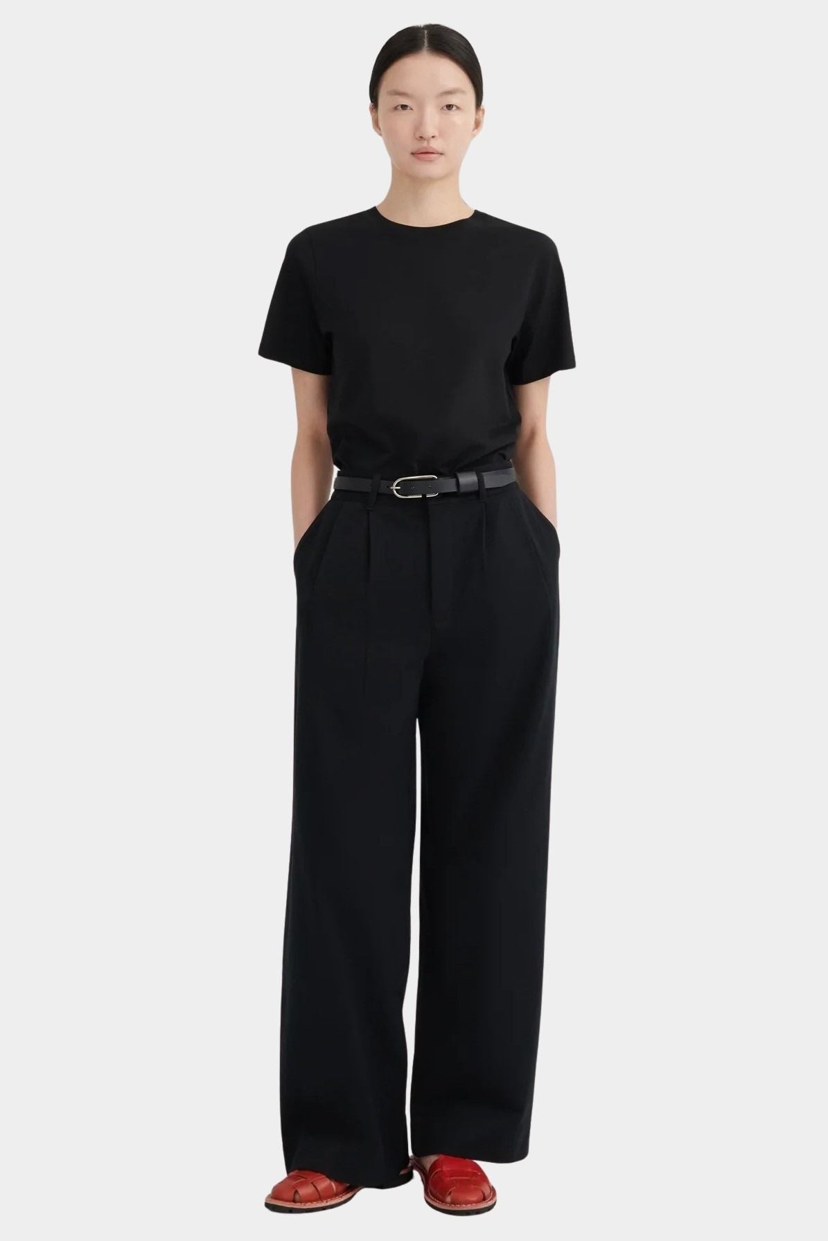 Full front view of the black Kowtow Franz Pant showing its high rise and wide straight silhouette.