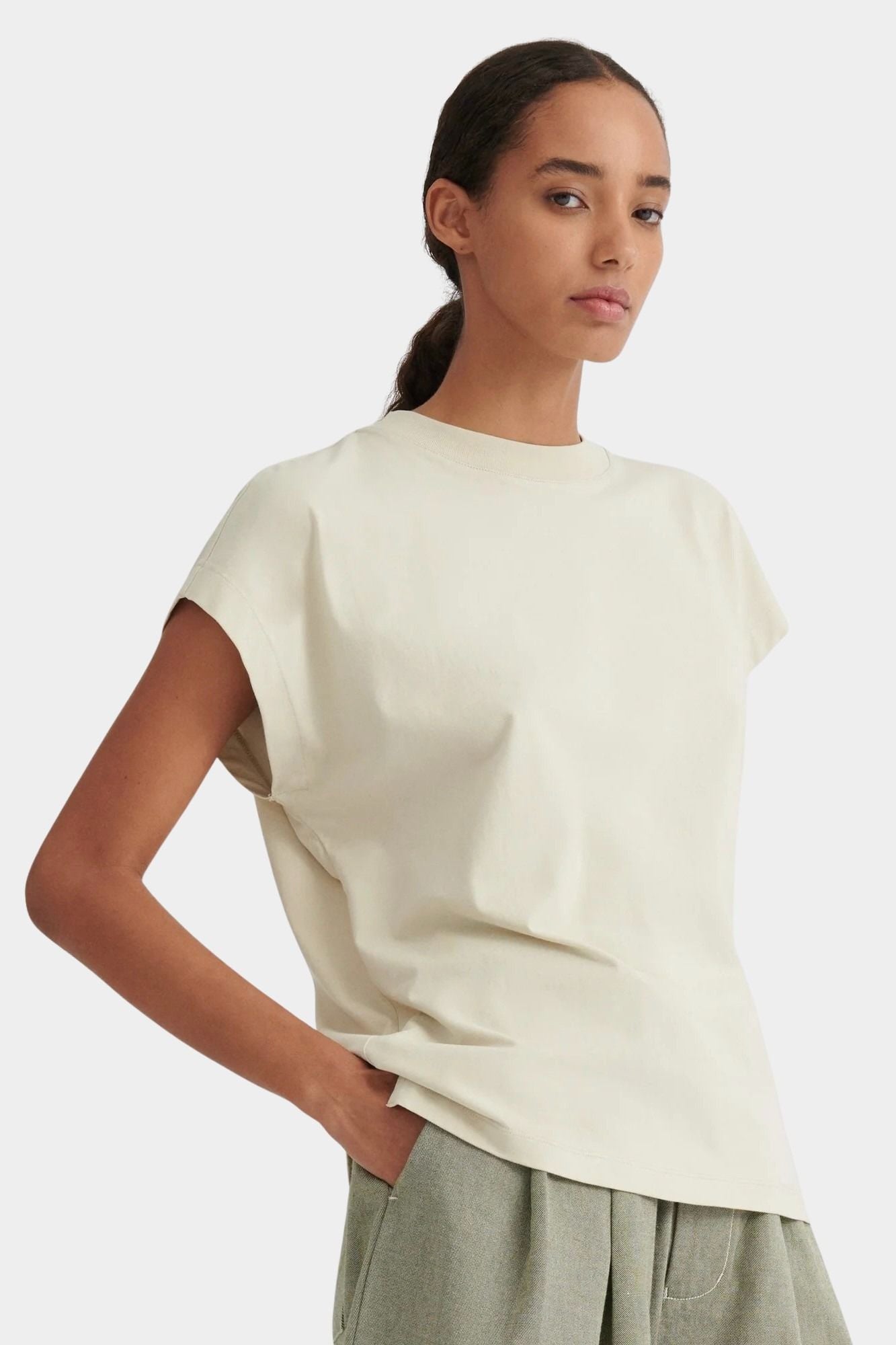 Angled front view of the Stone Kowtow Geometry Tee showing its relaxed shape and extended shoulders