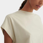 Close view of the ribbed neckline and soft cap sleeve shape of the Stone Kowtow Geometry Tee