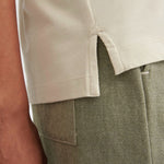 Close view of the side split at the hem of the Stone Kowtow Geometry Tee