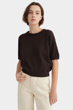Front view of the Sable Kowtow Shoreline Tee styled with cream trousers at YUCCA Denver
