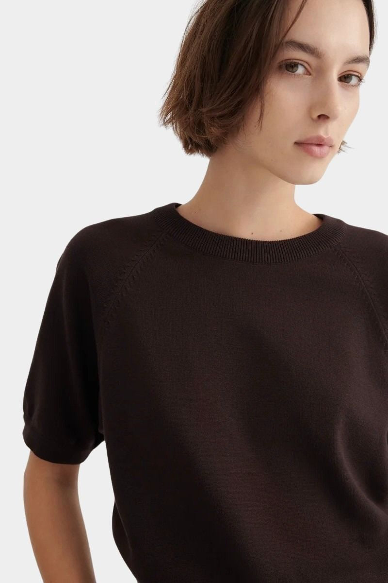 Close view of the Shoreline Tee’s ribbed neckline and raglan seams in Sable