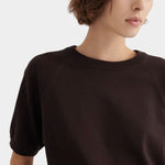 Close view of the Shoreline Tee’s ribbed neckline and raglan seams in Sable