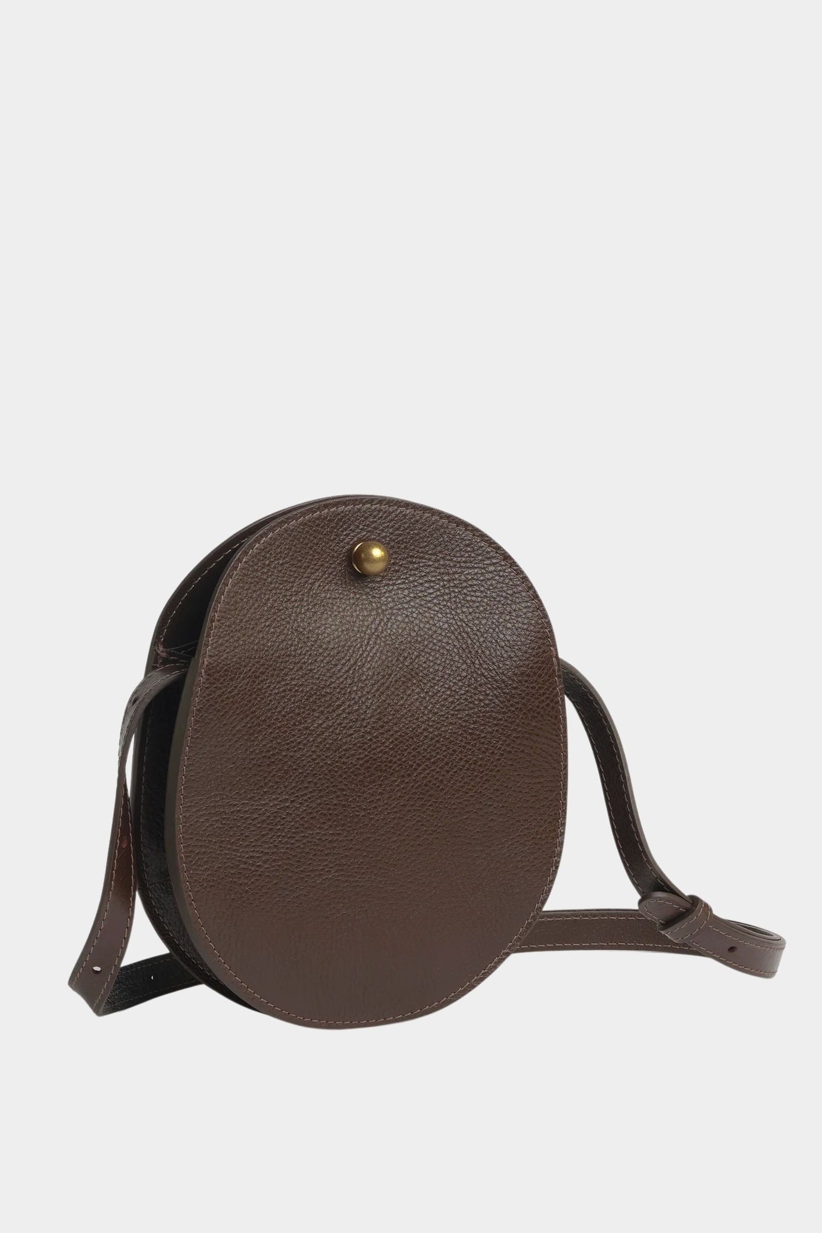 Angled view of the Chaga Eggi bag showing its rounded leather body, side gusset, and adjustable strap