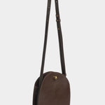 LINDQUIST Eggi crossbody bag in Chaga with its long leather strap extended above the oval body