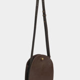 LINDQUIST Eggi crossbody bag in Chaga with its long leather strap extended above the oval body
