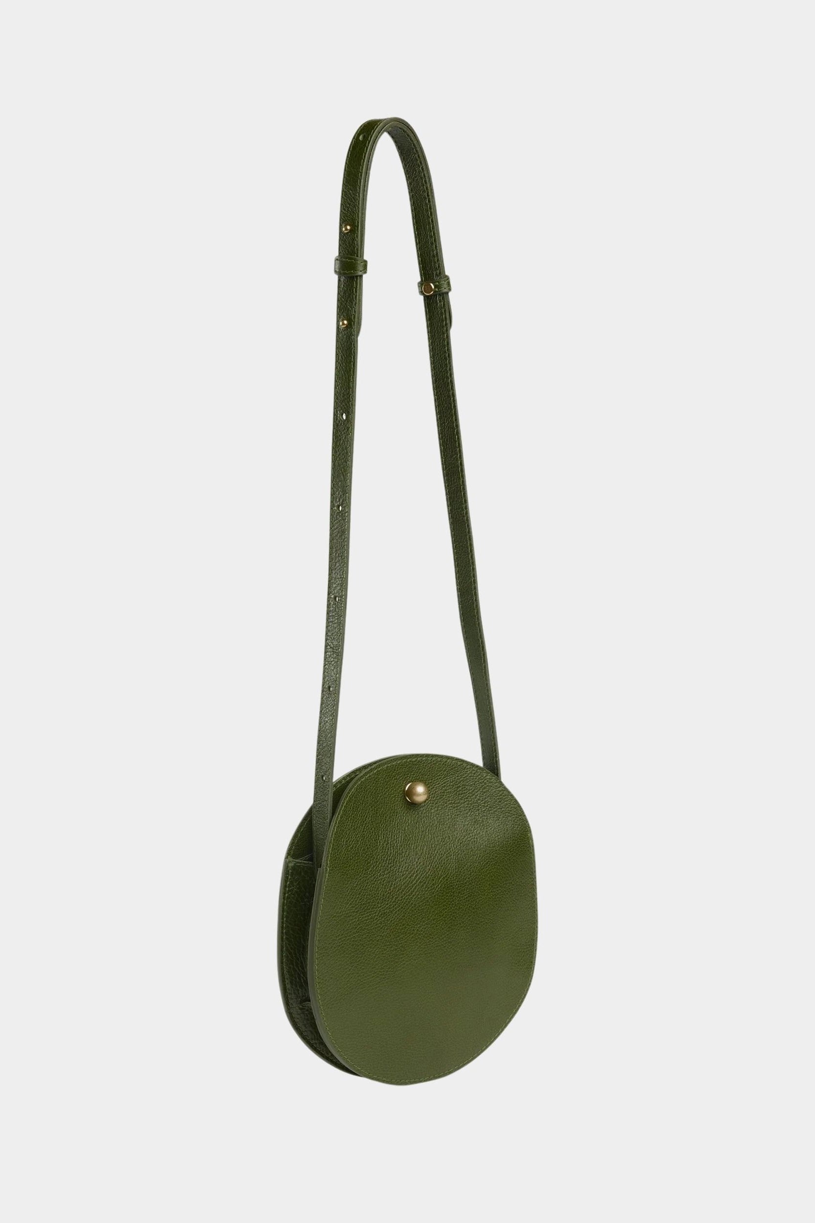 Eggi leather crossbody bag in Olive with its adjustable strap extended, offered at YUCCA in Denver