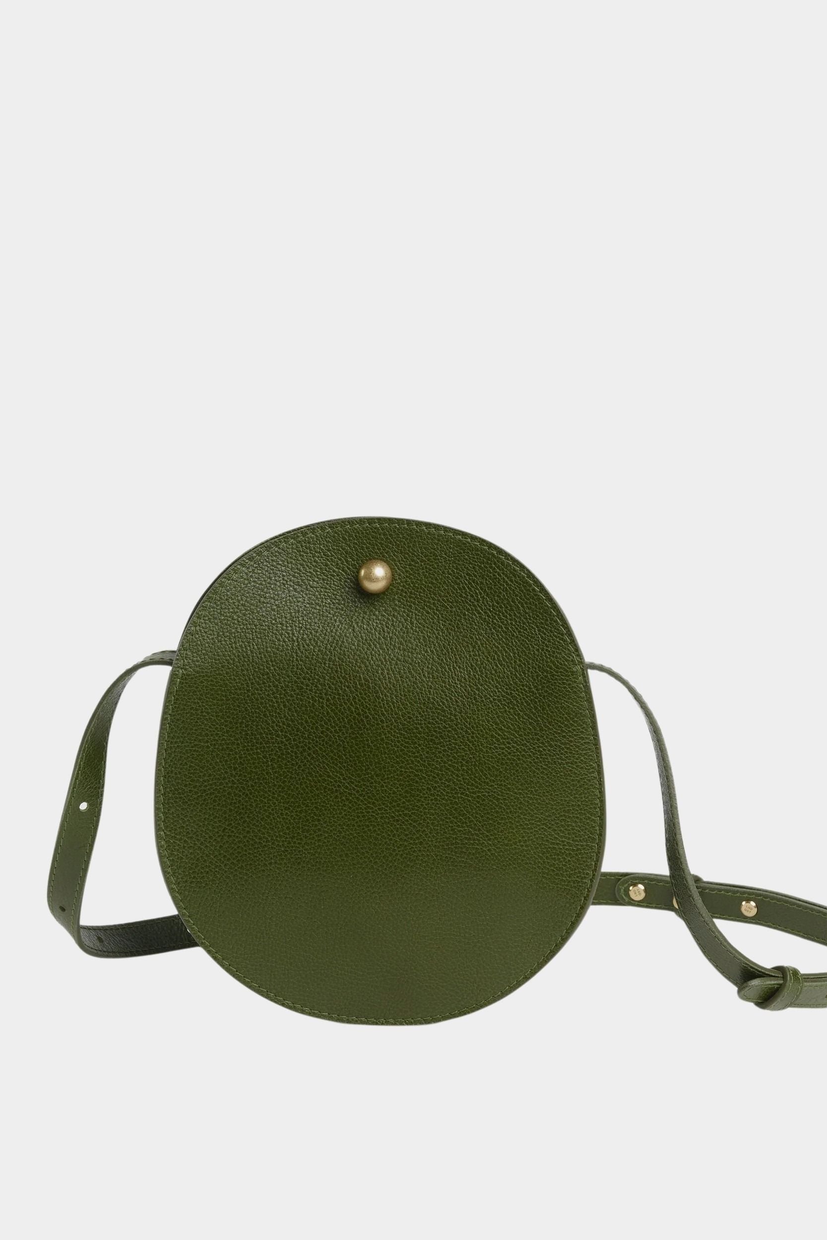 Front view of the Olive Eggi bag with its long leather strap arranged around the base