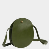 Angled view of the Olive Eggi leather bag showing its side gusset and adjustable shoulder strap