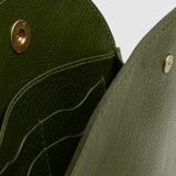 Open LINDQUIST Eggi bag in Olive showing leather card pockets, divided interior compartments, and brass snap