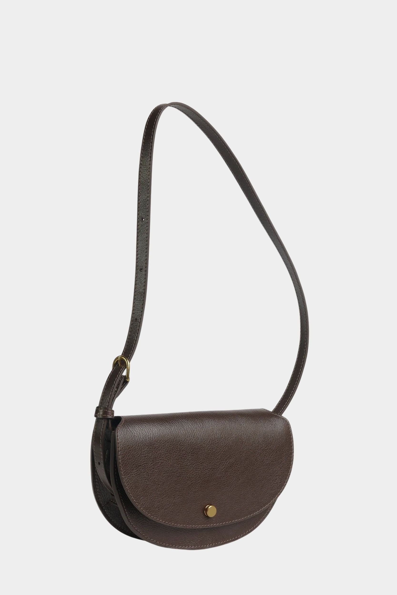 Angled view of the Chaga Mezzo shoulder bag showing its rounded flap and graduated side gusset