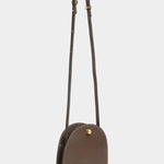 Mini Eggi leather crossbody bag in Chaga with its adjustable strap extended, offered at YUCCA in Denver