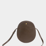 LINDQUIST Mini Eggi leather bag in Chaga with an oval silhouette, tonal stitching, and spherical brass snap