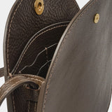 Open LINDQUIST Mini Eggi bag in Chaga showing divided leather compartments, card pockets, and brass snap