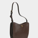 Angled view of the LINDQUIST Savoie bag in Chaga showing its rounded front and leather gusset