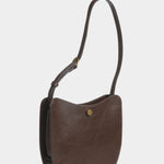 Image 70
LINDQUIST Savoie leather bag in Chaga with an adjustable strap and brass snap, offered at YUCCA in Denver