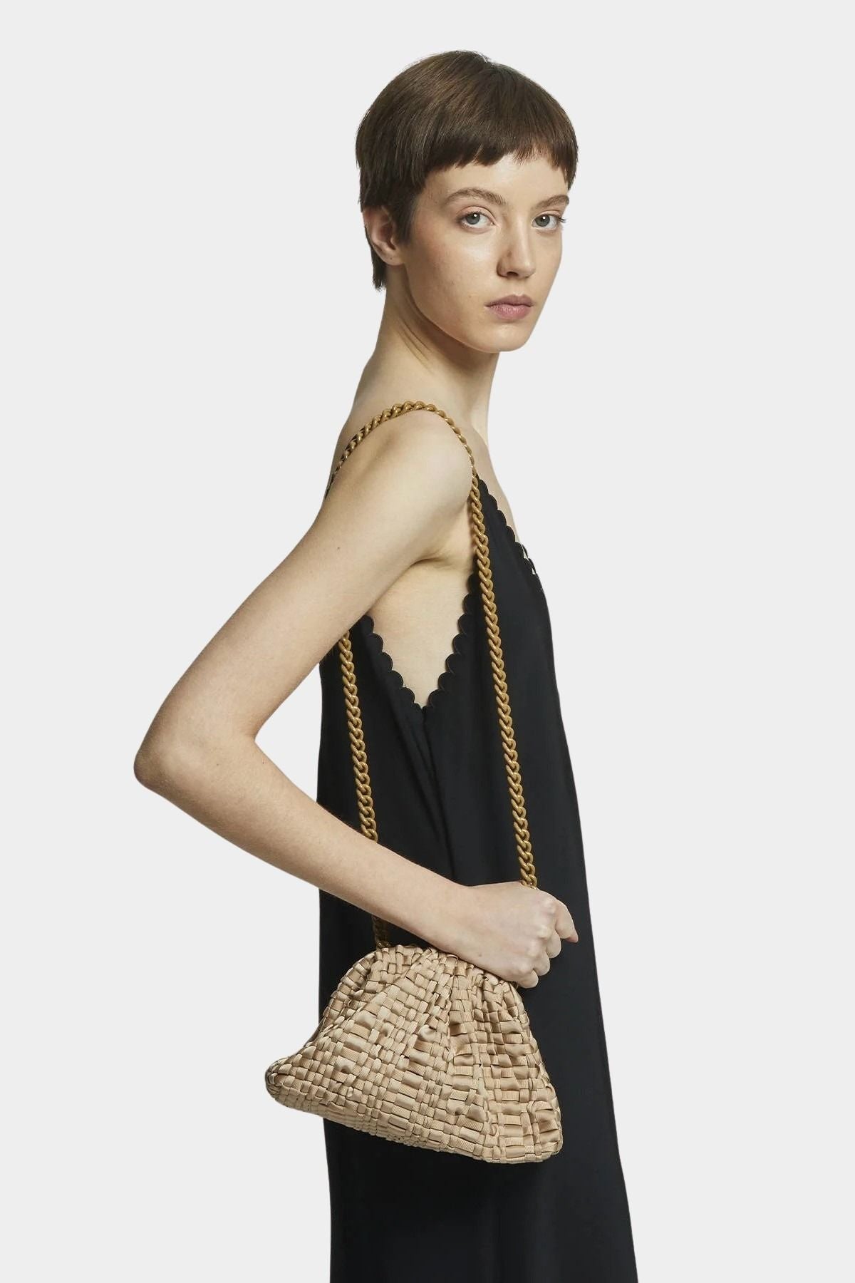 Model wearing Maria La Rosa Mini Game Bag in Biscotto as a crossbody bag