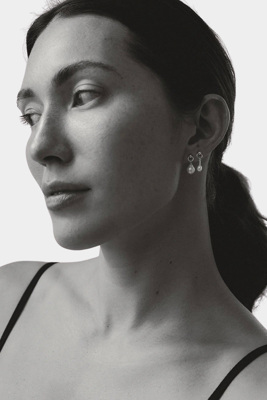 model wearing maslo balle pearl drop stud earrings sterling silver black and white