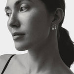 model wearing maslo balle pearl drop stud earrings sterling silver black and white