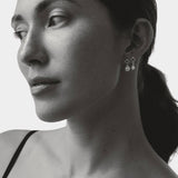 model wearing maslo balle pearl drop stud earrings sterling silver black and white