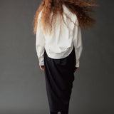 Back view of the Mijeong Park Asymmetric Cotton Shirt in white showing its rounded hem