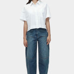 Mijeong Park blue barrel leg patch pocket denim full front view relaxed mid rise barrel jeans styled with white shirt