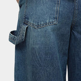 Mijeong Park blue barrel leg patch denim close up showing back pocket detail utility loop and structured cotton denim