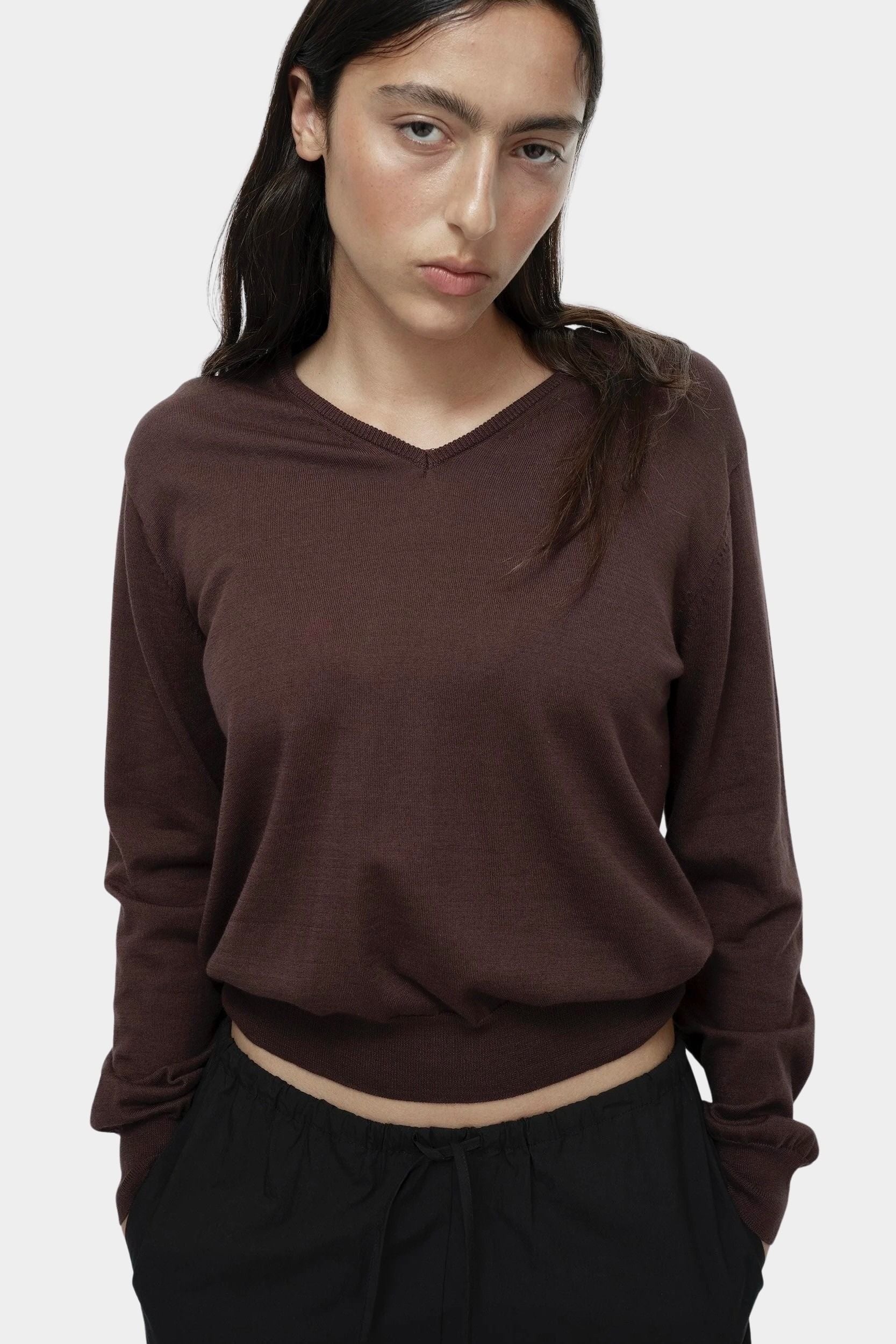 Close-up of brown cotton blend v neck knit top by Mijeong Park showing lightweight knit texture