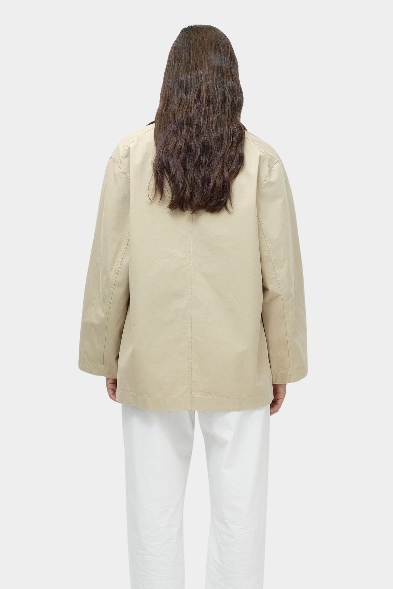 Back view of linen blend work jacket in beige by Mijeong Park with oversized silhouette