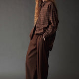 Angled view of the Mijeong Park Oversized Plaid Shirt showing its relaxed fit and long sleeves