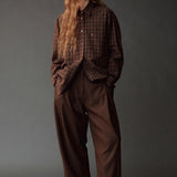 Front view of the Mijeong Park brown plaid shirt styled with relaxed brown trousers