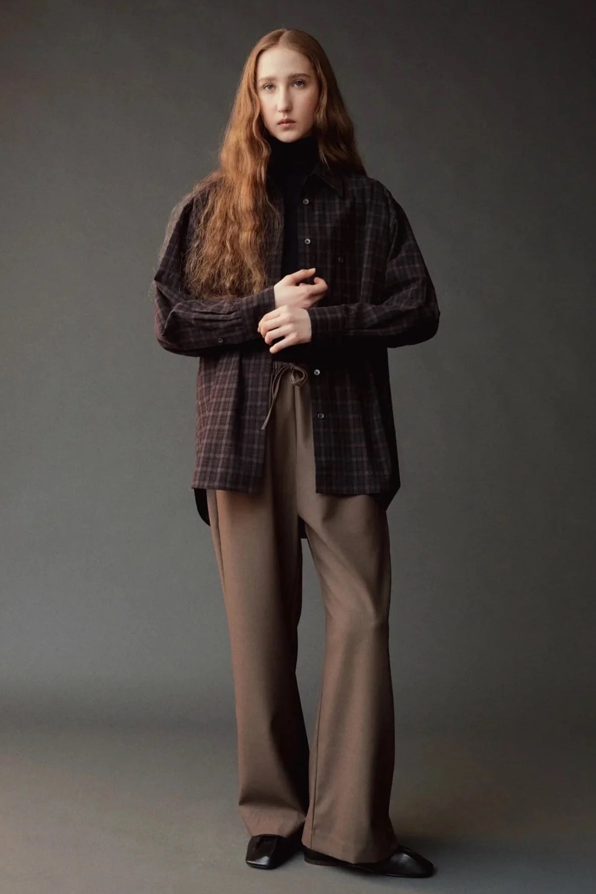 Front view of the Mijeong Park brown plaid shirt layered over a black turtleneck