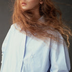 Close front view of the Mijeong Park light blue shirt showing the collar, buttons, and chest pocket