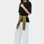 Mijeong Park oversized black cotton t shirt relaxed minimalist crewneck tee styled outfit white wide leg trousers womens designer clothing