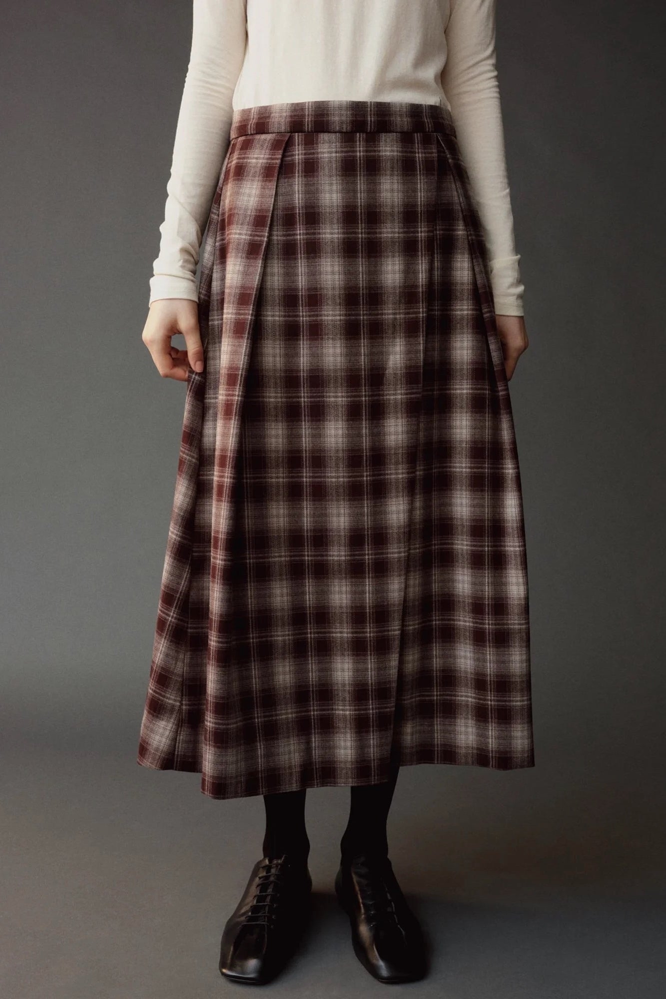 Close front view of the Mijeong Park Plaid Midi Skirt showing the waistband and pleat detailing
