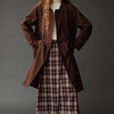 Mijeong Park brown plaid midi skirt styled with an oversized brown coat and ivory turtleneck