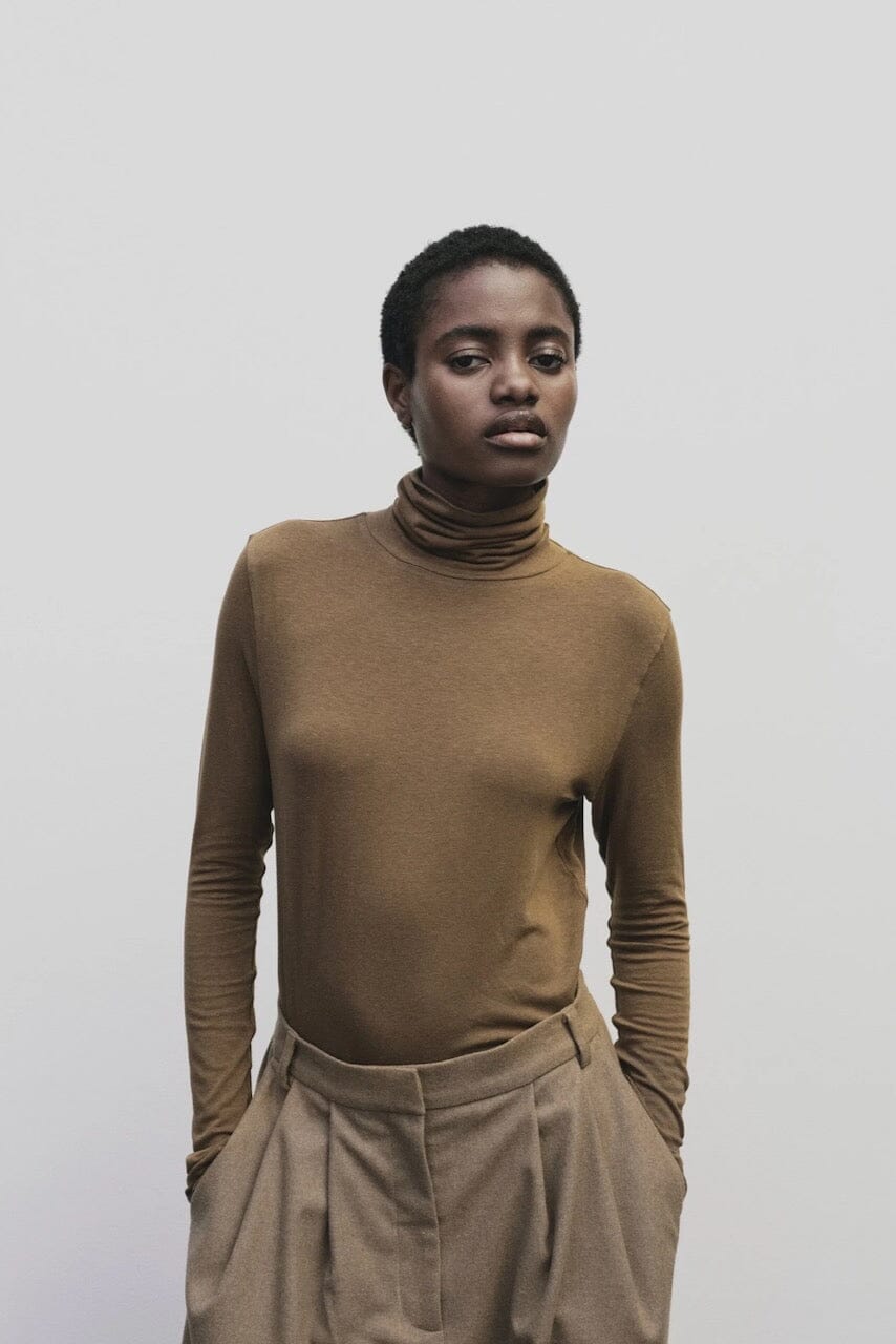 Light brown slim fit roll neck jersey top by Mijeong Park