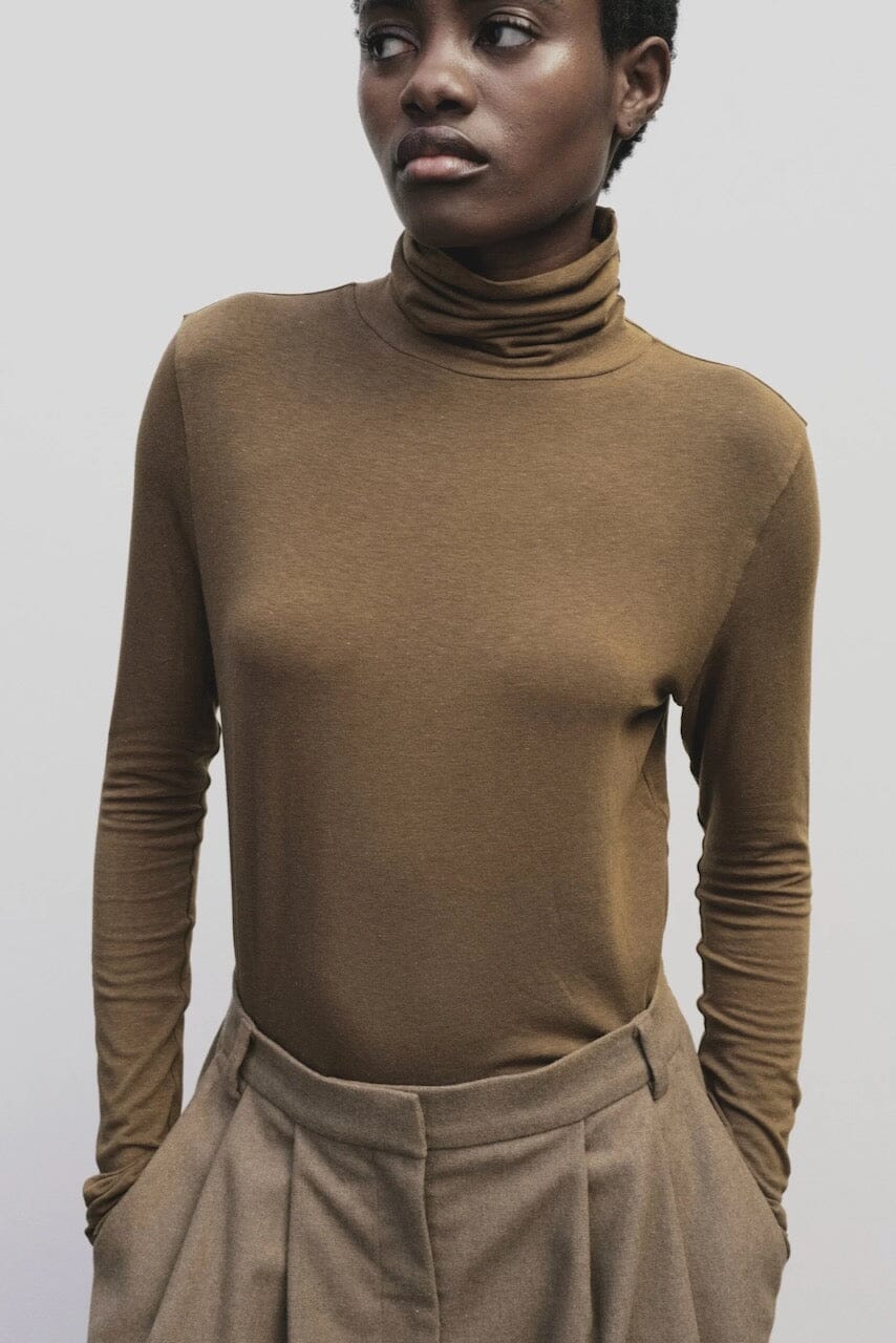 Light brown slim fit roll neck jersey top by Mijeong Park