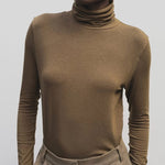 Light brown slim fit roll neck jersey top by Mijeong Park