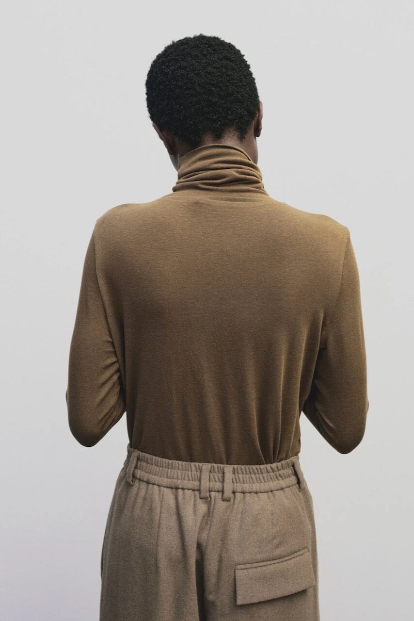 Light brown slim fit roll neck jersey top by Mijeong Park