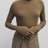 Light brown slim fit roll neck jersey top by Mijeong Park