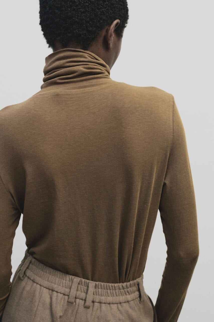 Light brown slim fit roll neck jersey top by Mijeong Park