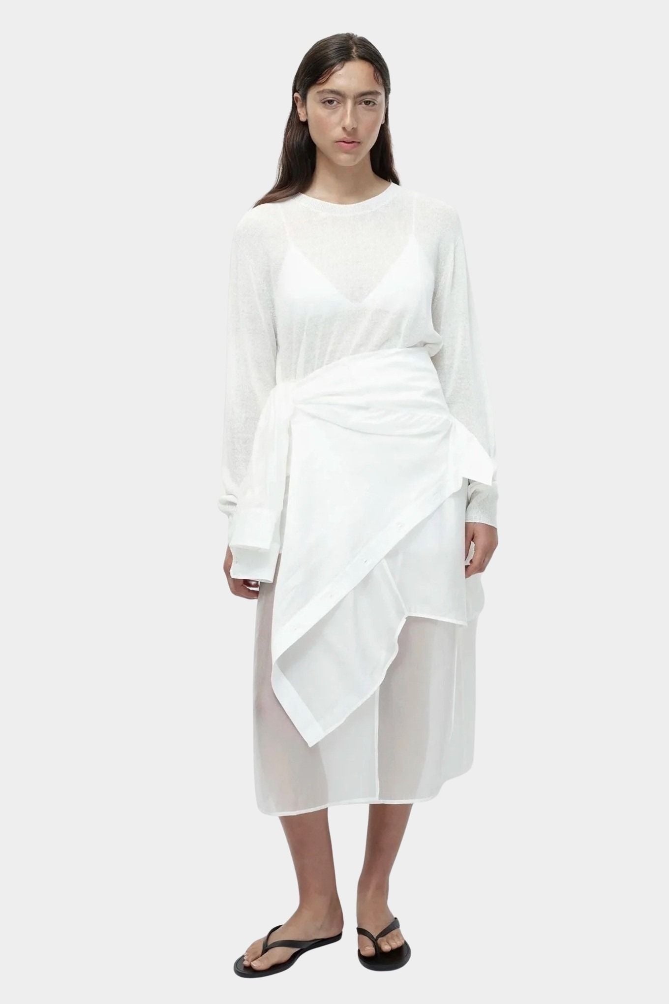 Semi sheer linen blend knit top in white by Mijeong Park, lightweight crewneck sweater with relaxed fit, styled over sheer skirt
