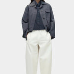 Oversized navy cotton poplin short sleeve shirt with cropped length styled with cream wide leg trousers