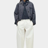Oversized navy cotton poplin short sleeve shirt with cropped length styled with cream wide leg trousers