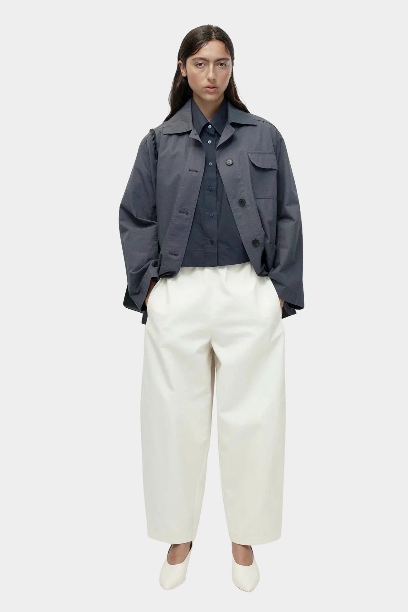 Oversized navy cotton poplin short sleeve shirt with cropped length styled with cream wide leg trousers
