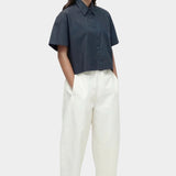 Cropped navy cotton poplin short sleeve shirt styled with relaxed cream trousers