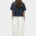 Back view of cropped navy cotton poplin short sleeve shirt with boxy silhouette