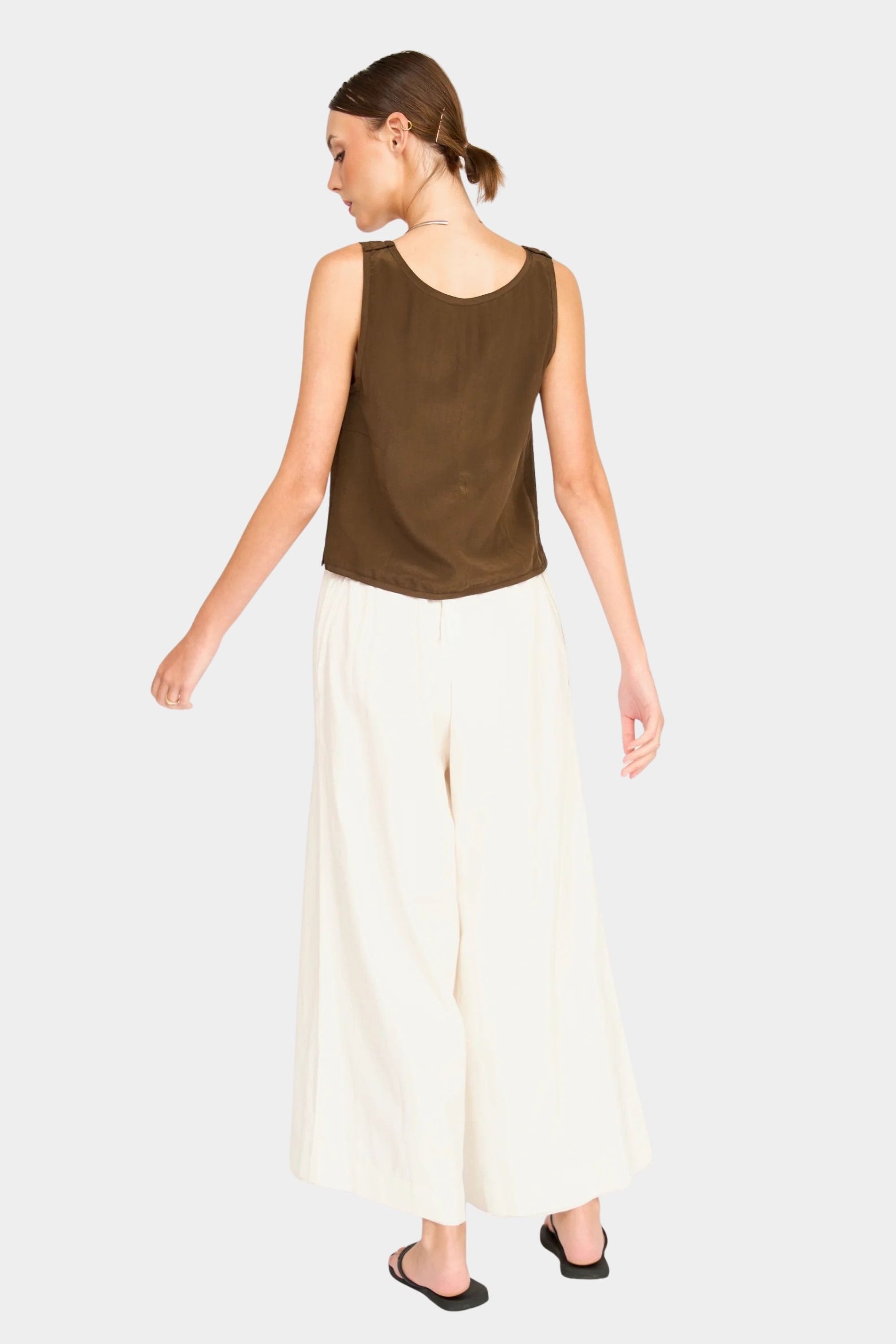 Side/back view of brown sleeveless tank showing relaxed drape and low armholes