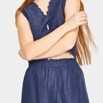 Front view of blueberry wide leg pants styled with brown vest and relaxed fit